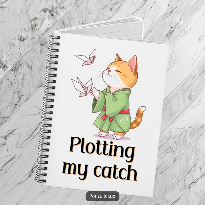 Funny cat in a green kimono playfully attempting to catch a floating origami crane, a cute and funny notebook.